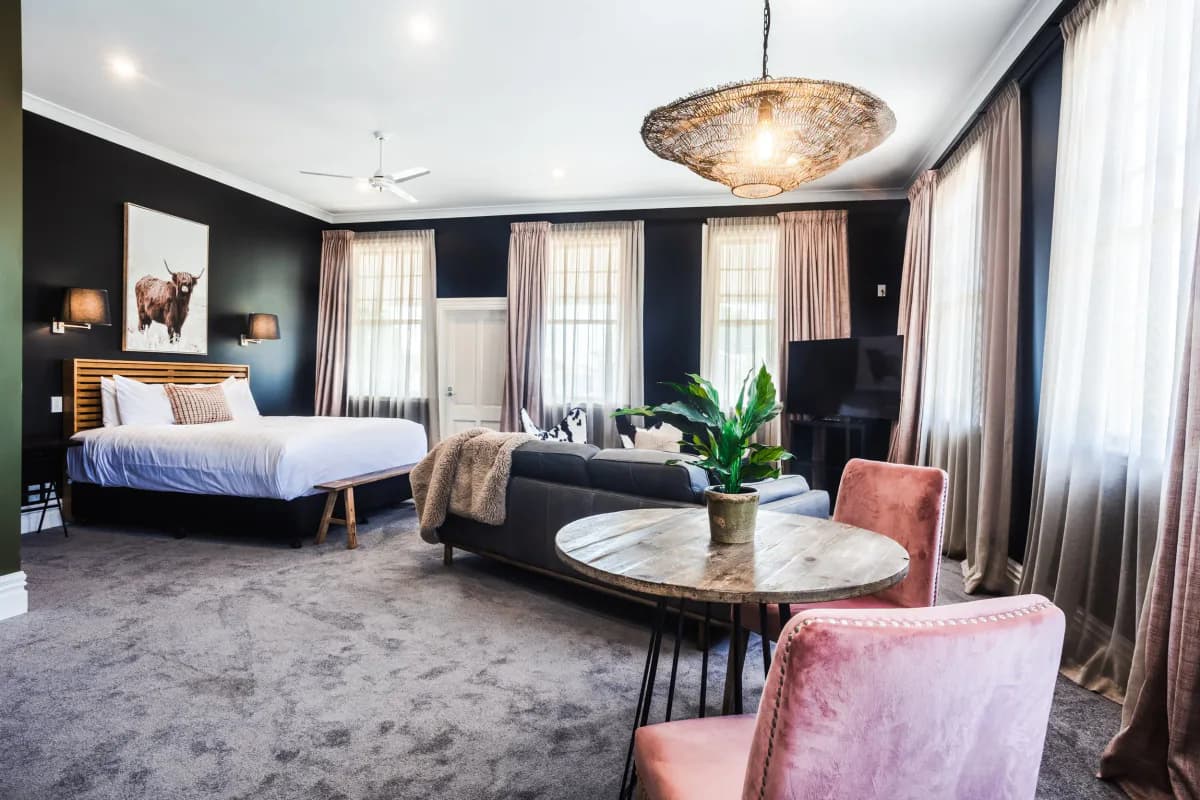 A sunlit bedroom opening onto the balcony at The White Swan Country Hotel